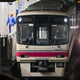 A Keio Line subway train brought to a stop on the train tracks.